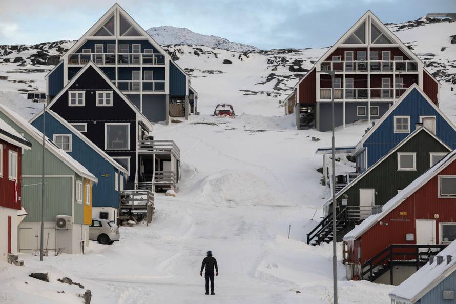 A man stands on a street on the day of the meeting between top U.S. officials and the foreign ministers of Denmark and Greenland, in Nuuk