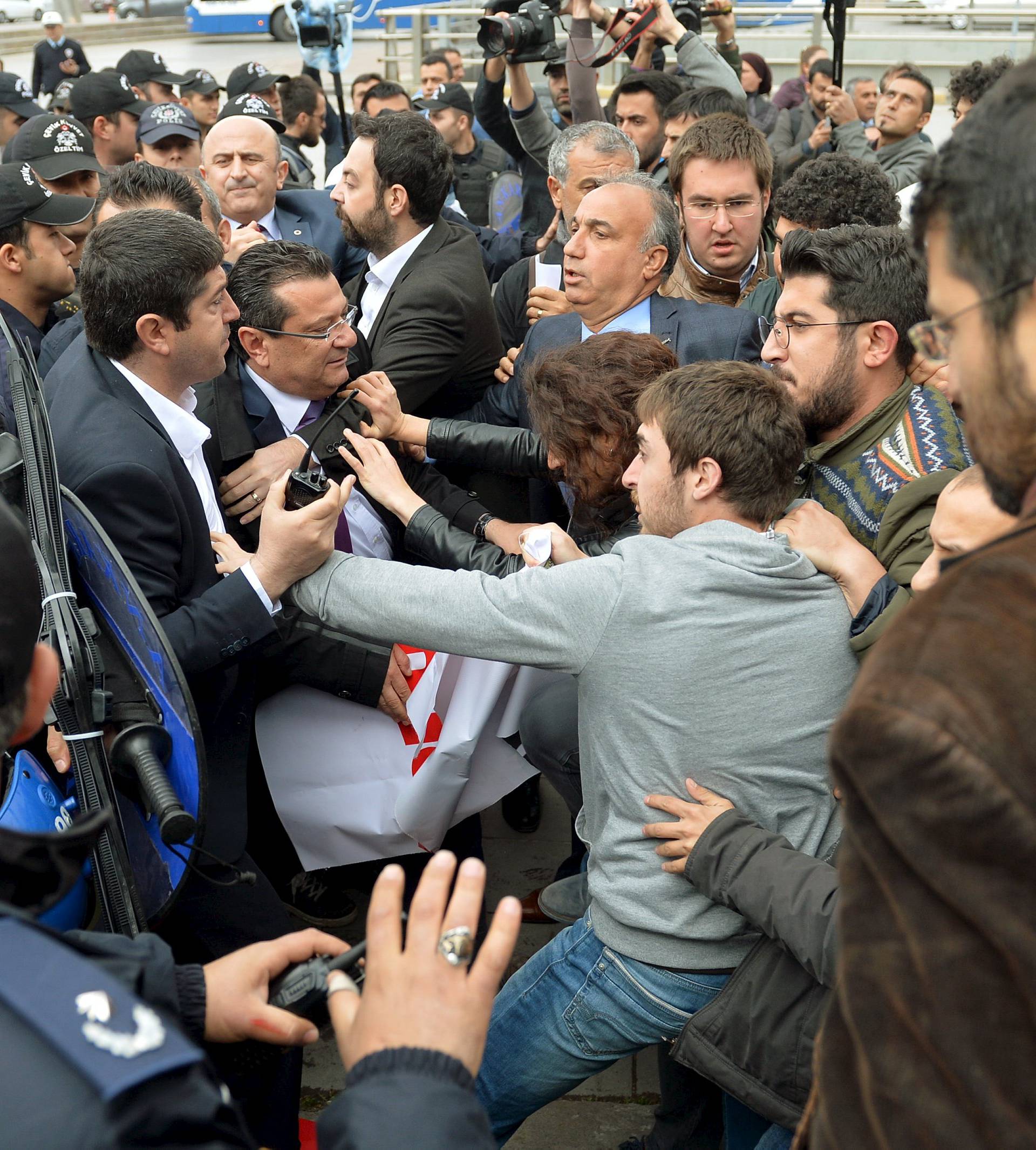 Riot police scuffle with demonstrators during a protest against parliament speaker Ismail Kahraman, outside the Turkish parliament in Ankara