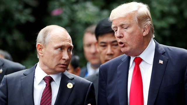 FILE PHOTO: U.S. President Donald Trump and Russia's President Vladimir Putin talk during the family photo session at the APEC Summit in Danang