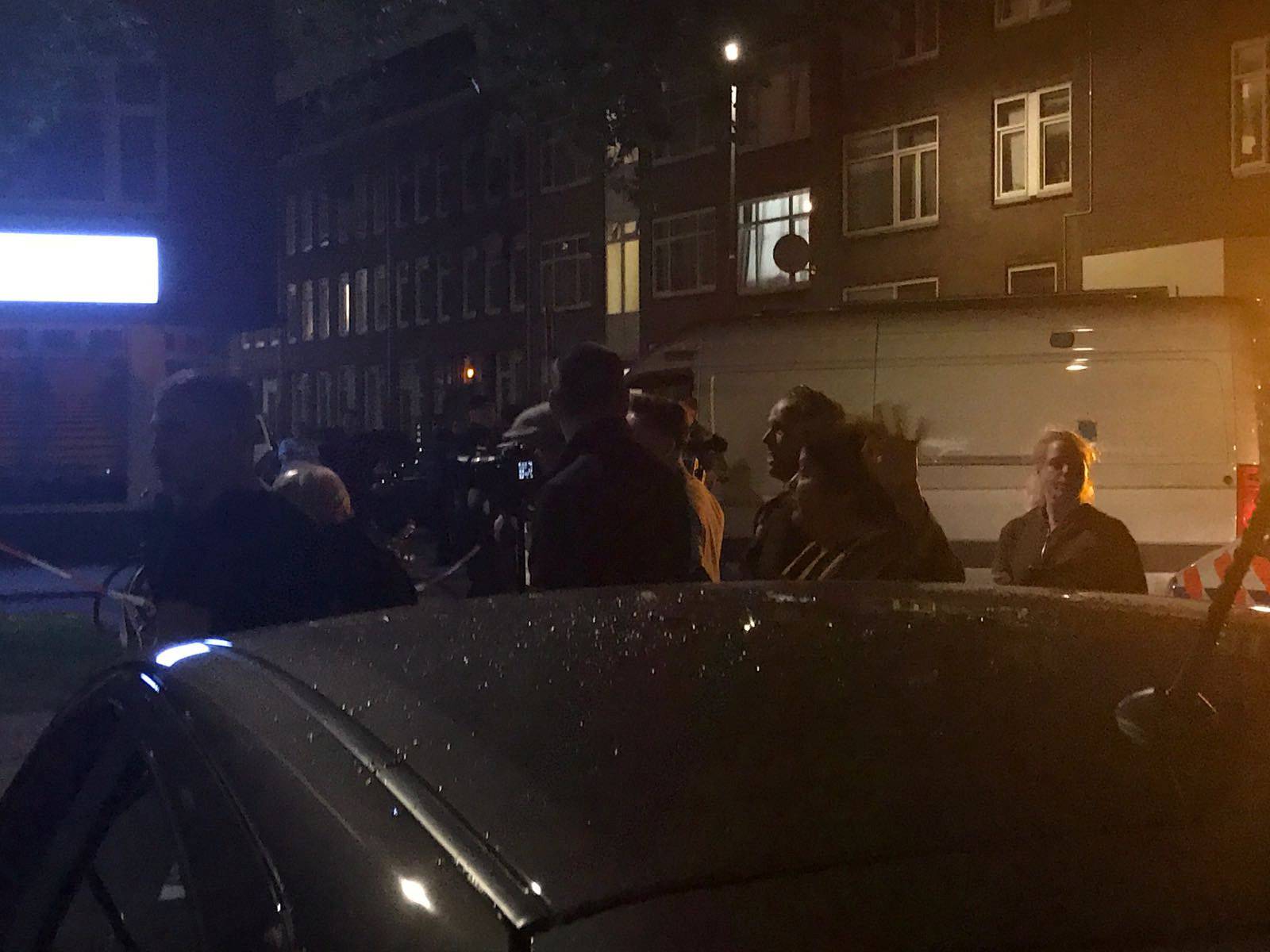 People gather at the scene where police are investigating a van with Spanish licence plates containing gas bottles which was found near a concert hall in Rotterdam