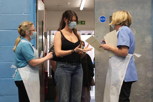 Students wait in line at the entrance to the sports hall at University of Kent campus in Canterbury, where the rollout of a meningitis B vaccine to about 5,000 students has begun. Thousands of students in Kent are to be offered vaccines in the coming days
