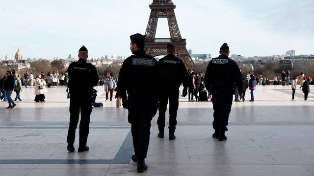 French police and gendarmes patrol near the Eiffel Tower in Paris