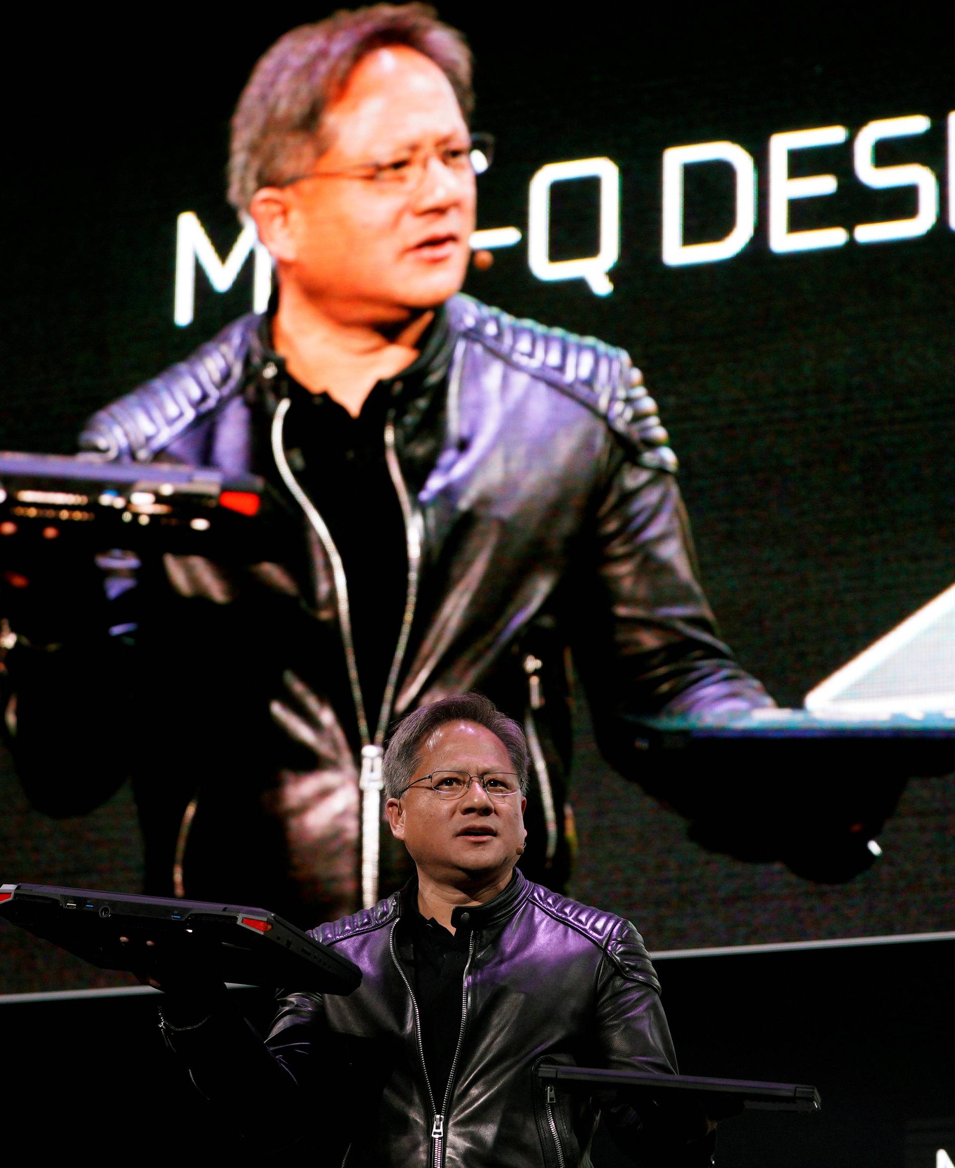 Jensen Huang, CEO of Nvidia, shows the old and new Max-Q laptops at his keynote address at CES in Las Vegas