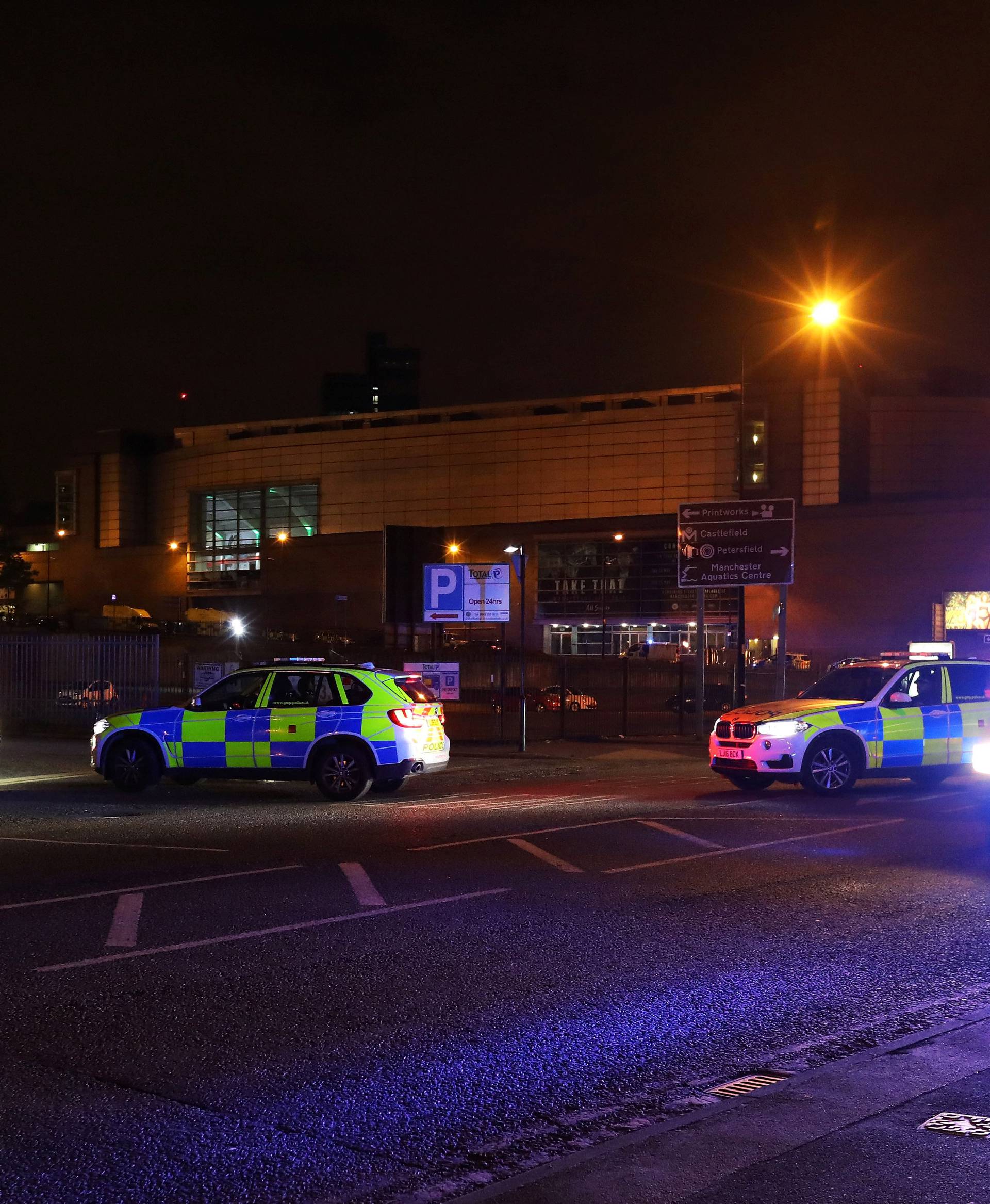 Police vehicles are seen outside the Manchester Arena, where U.S. singer Ariana Grande had been performing, in Manchester, northern England, Britain