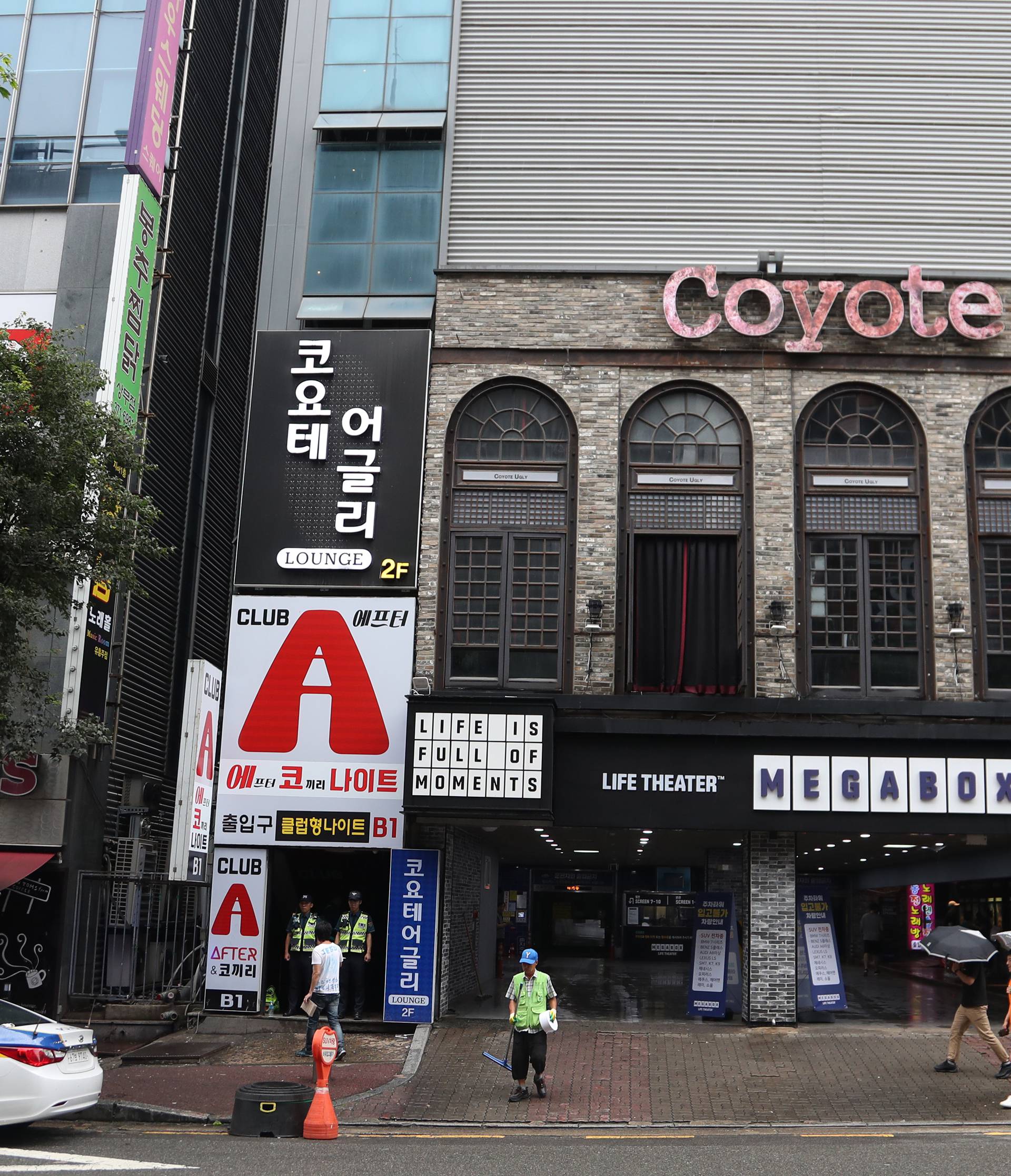 Police secure the area outside a night club after its upper floor collapsed in Gwangju