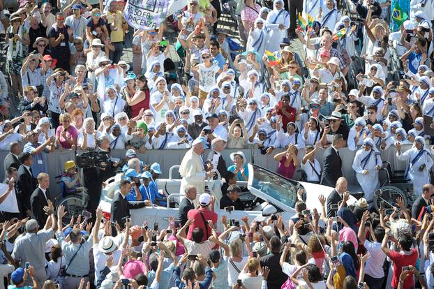 Pope Francis waves as he arrives for  the audience for workers ad volunteers of Mercy at the Vatican