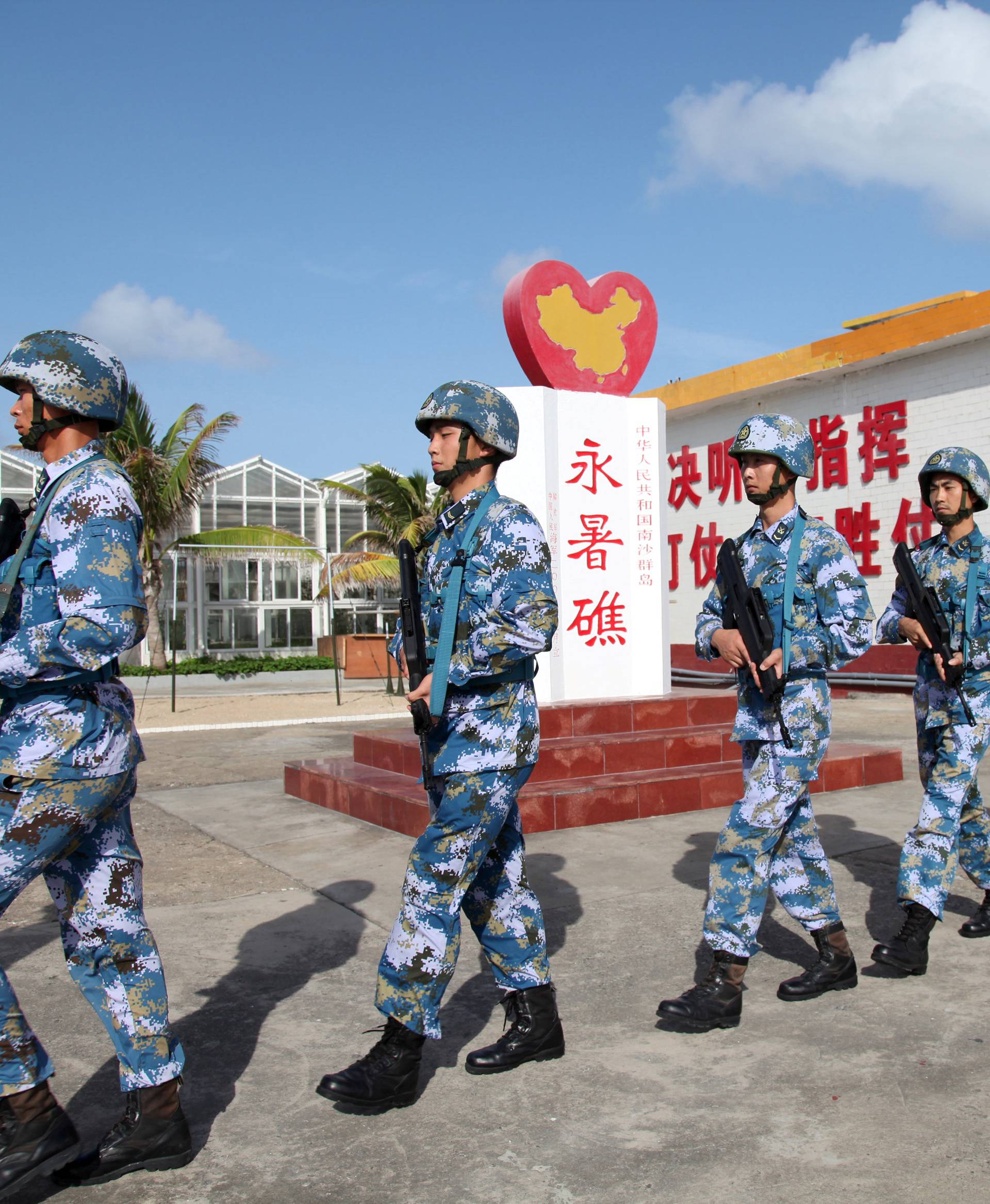 Soldiers of China's People's Liberation Army (PLA) Navy patrol at Fiery Cross Reef, in the Spratly Islands, known in China as the Nansha Islands