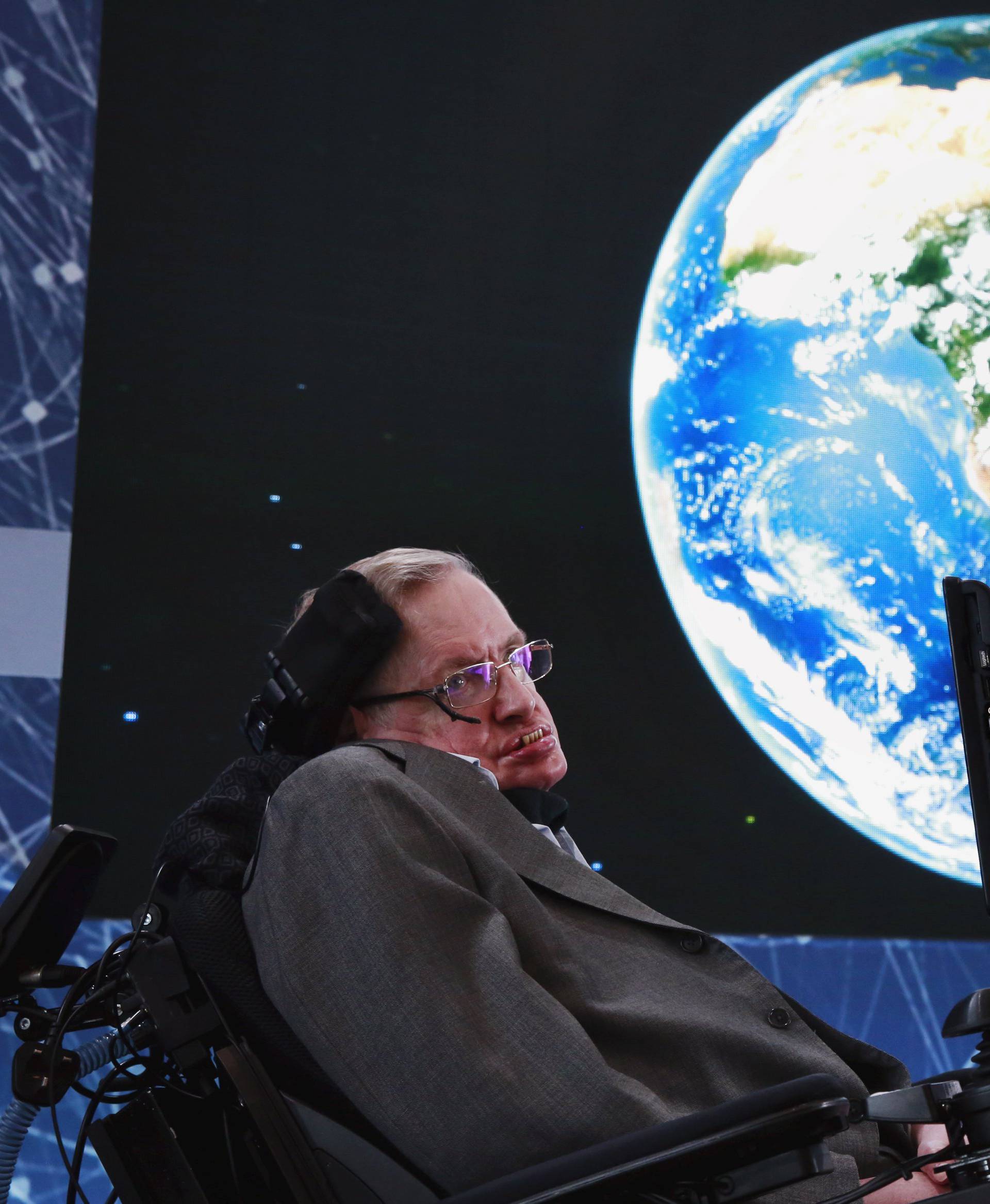 Physicist Stephen Hawking sits on stage during an announcement of the Breakthrough Starshot initiative with investor Yuri Milner in New York 