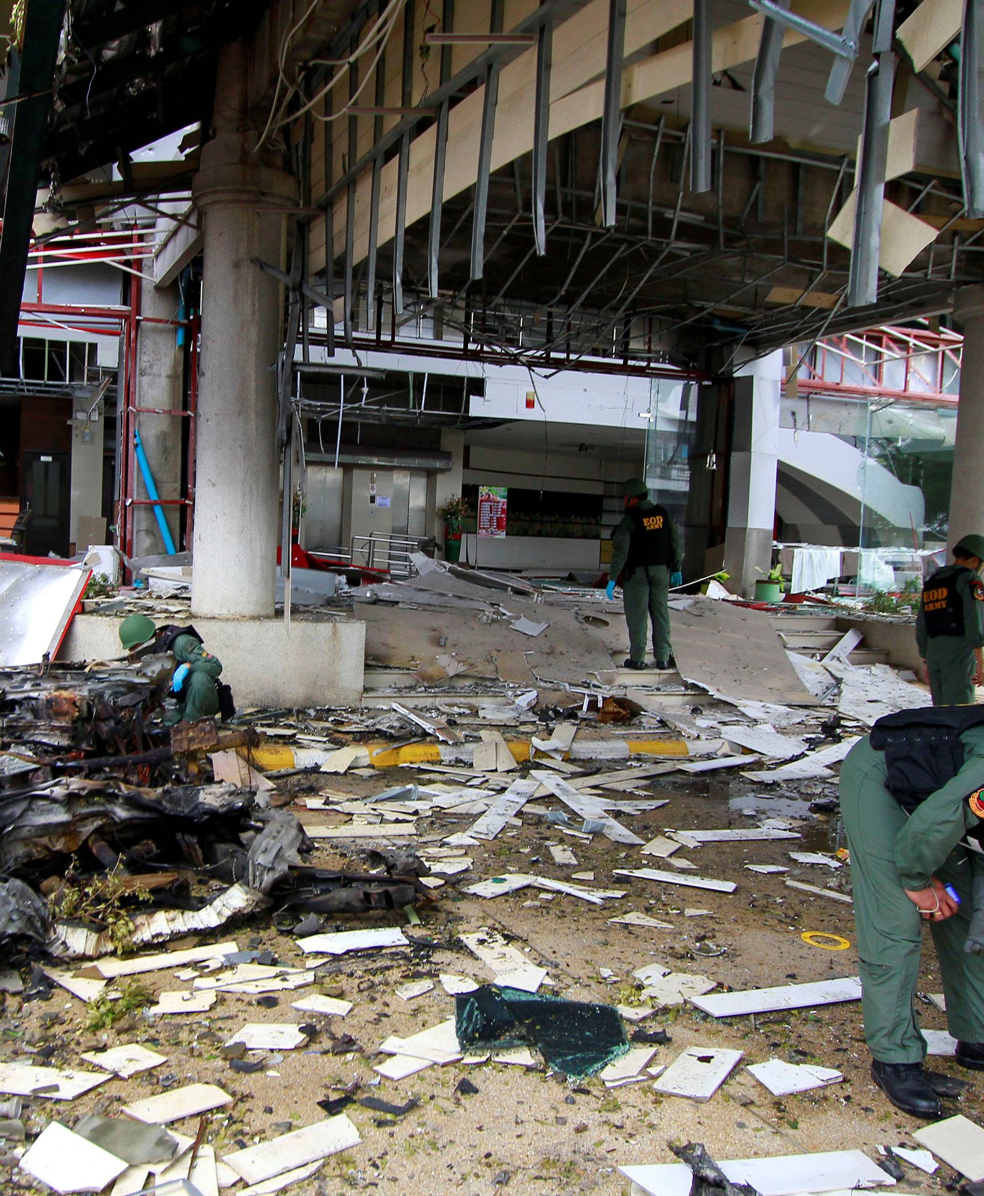 Thai soldiers inspect the scene of a car bomb blast outside a hotel in the southern province of Pattani