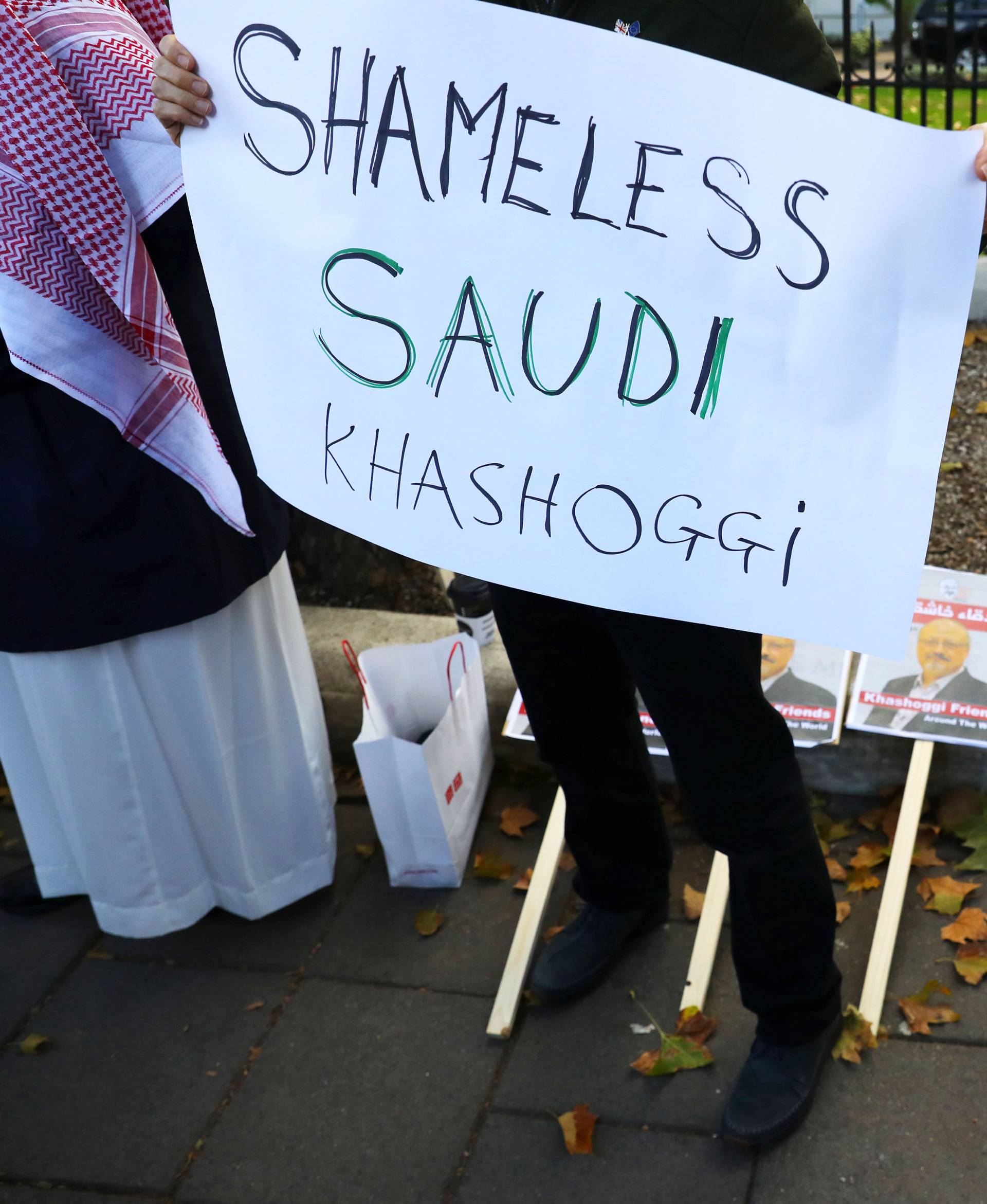 Placards can be seen outside the embassy as people protest against the killing of journalist Jamal Khashoggi in Turkey outside the Saudi Arabian Embassy in London