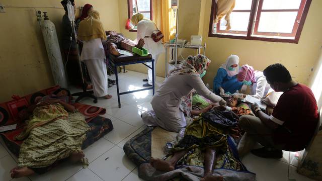 Injured people receive medical attention at a hospital following an earthquake in Sigli, Pidie regency, in the northern province of Aceh