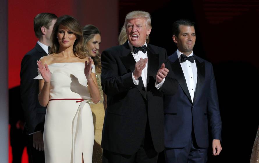 U.S. President Donald Trump applauds while flanked by his wife Melania and his son Donald Jr. at his "Liberty" Inaugural Ball in Washington