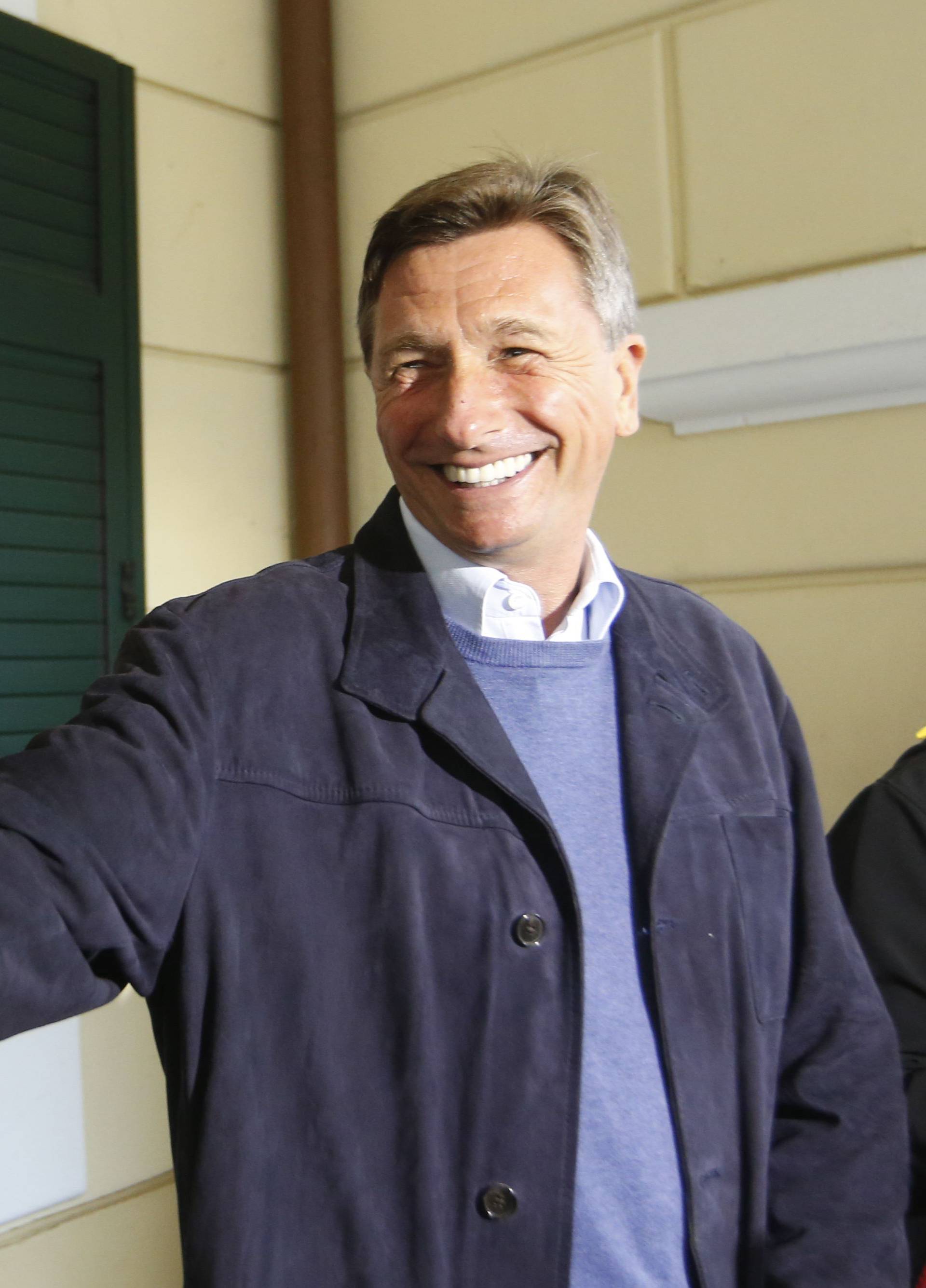 Presidential candidate Borut Pahor reacts as he talks to the media during the presidential election outside a polling station in Sempeter pri Novi Gorici