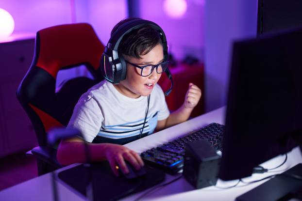 Adorable,Hispanic,Boy,Streamer,Playing,Video,Game,With,Winner,Expression
