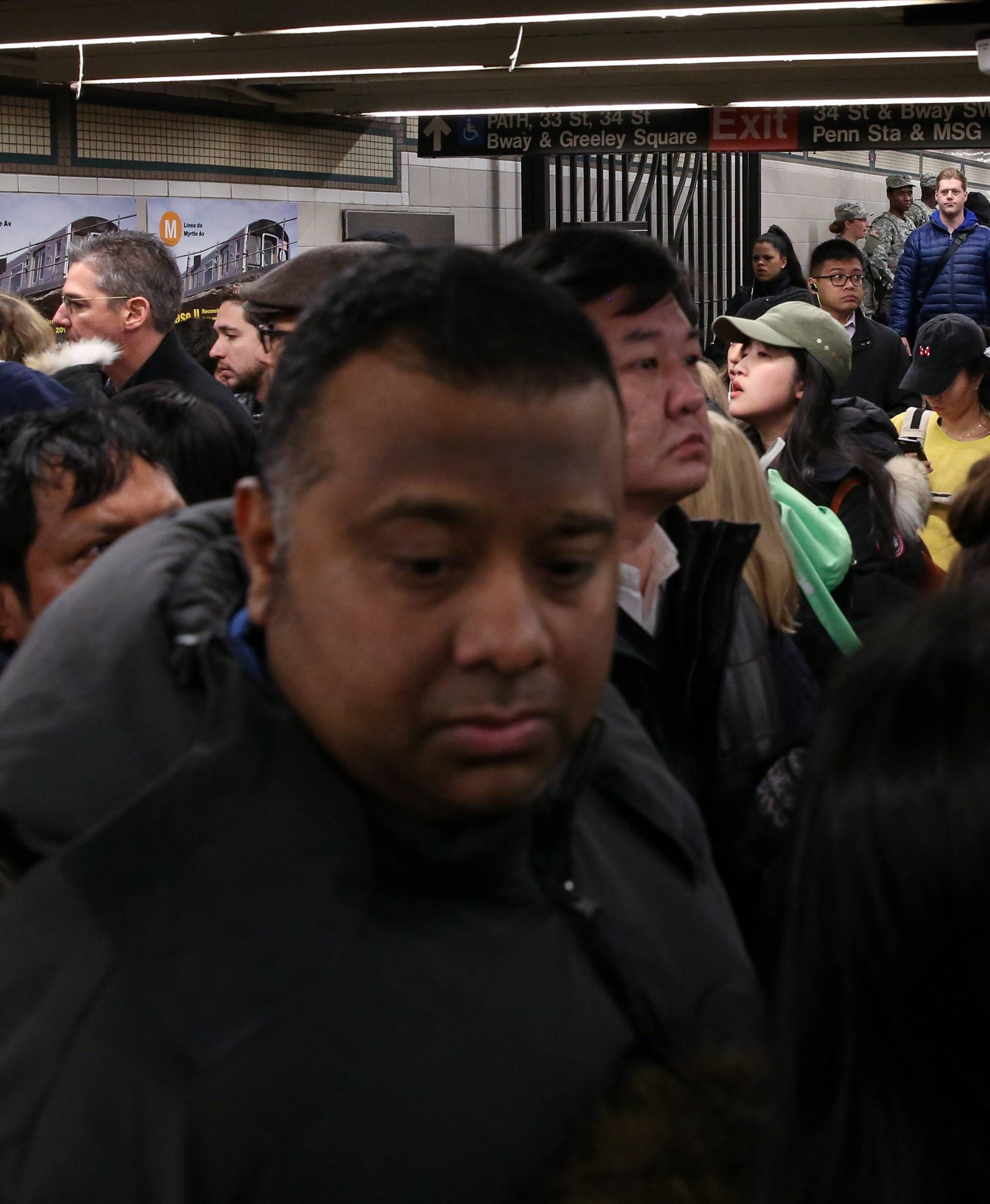 A crowd of New York City subway commuters gather at 34th St - Herald Square station after an explosion near the Port Authority Bus Terminal in New York