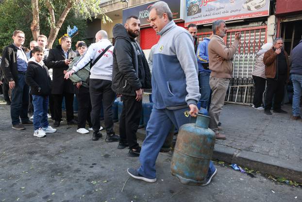 People queue to fill their gas cylinders in Damascus