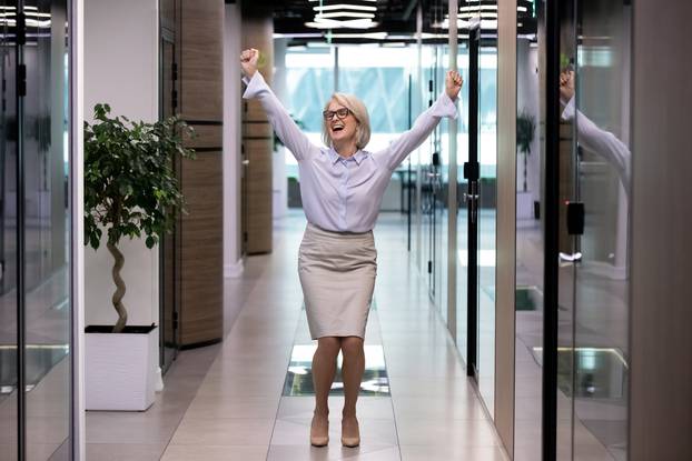 Happy,Middle-aged,Business,Lady,Celebrates,Personal,Business,Goal,Achievements,Standing