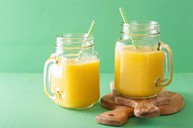 healthy mango pineapple smoothie in mason jars
