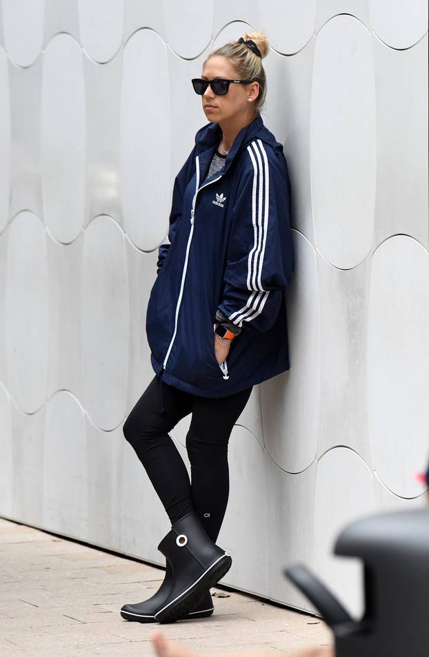EXCLUSIVE: Anna Kournikova is dressed down in an Adidas jacket and Croc's rain boots as she waits for her car in Miami