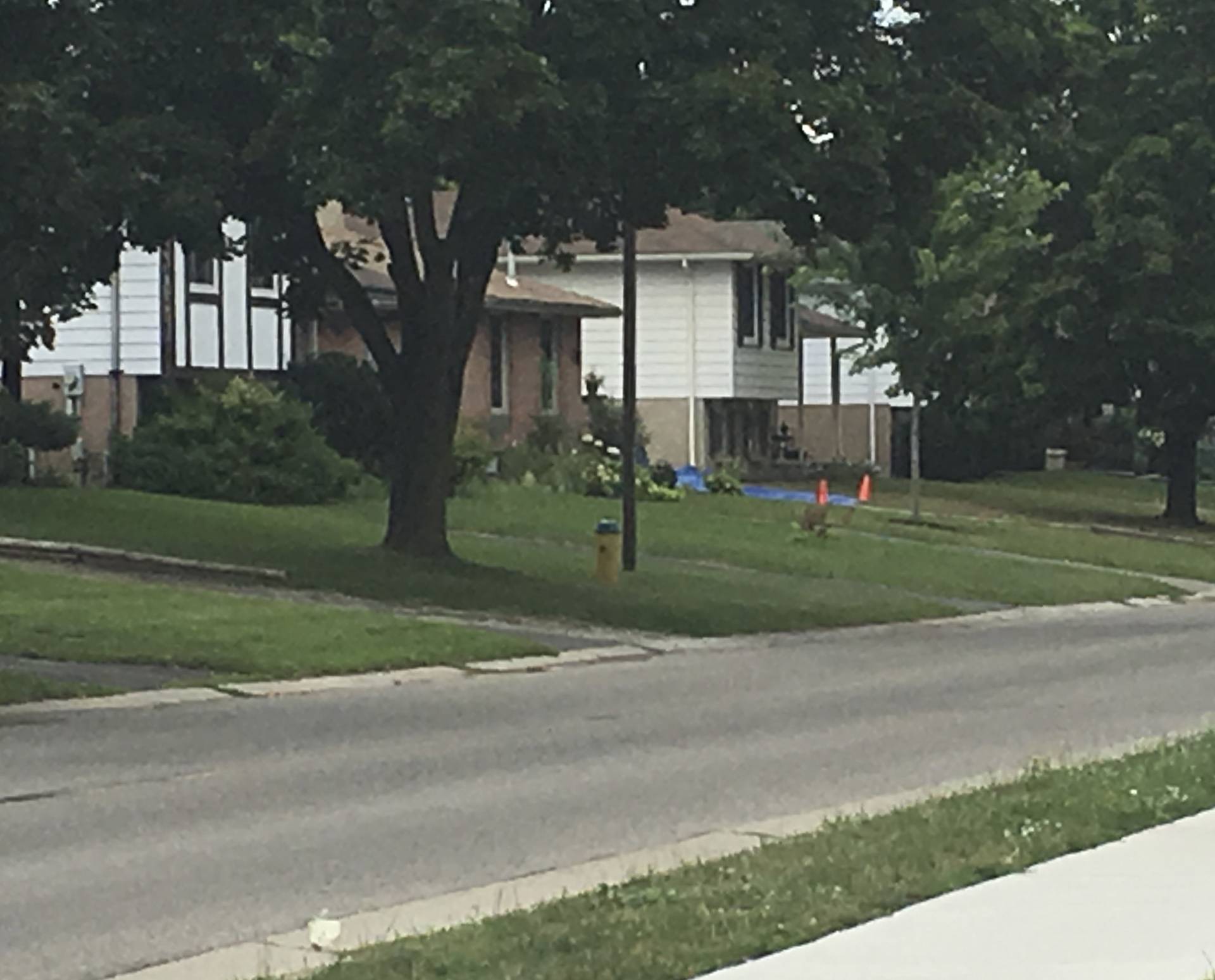 Red cones and a tarp are seen outside a home believed to be the residence of Aaron Driver, who had indicated he planned to carry out an imminent rush-hour attack on a major Canadian city, in Strathroy