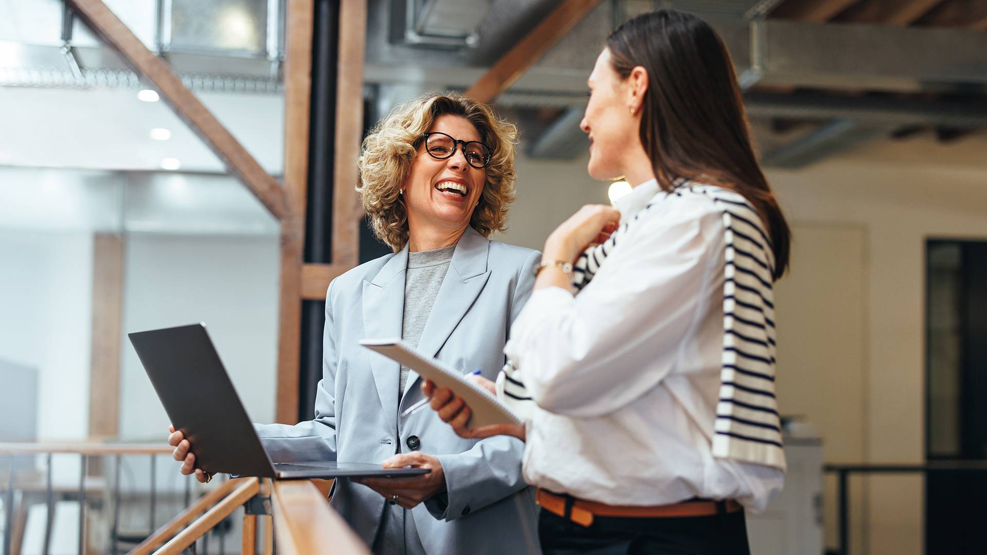 Business,Women,Smiling,As,They,Have,A,Meeting,On,A