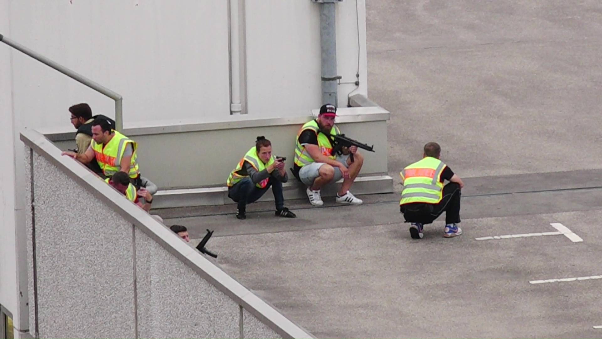 Screen grab shows plain clothes police officers taking cover in car park of shopping mall during shooting rampage in Munich