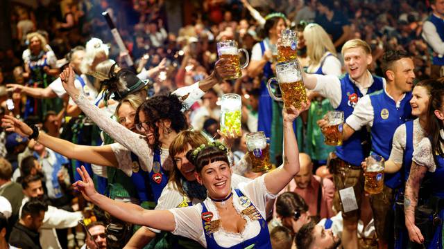 Oktoberfest waitresses toast with beer while they celebrate the end of the 189th Oktoberfest in Munich