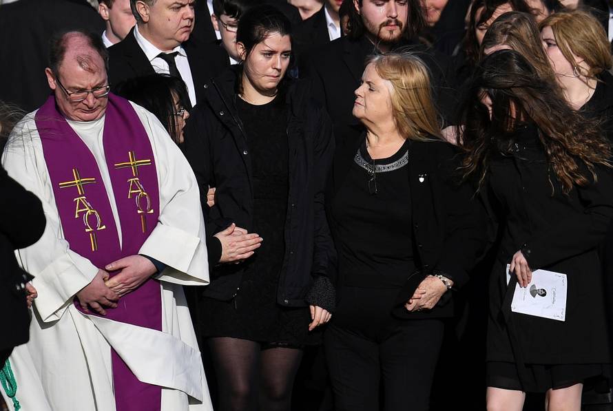 Eillen O'Riordan leaves her daughter Dolores O'Riordan's funeral with one of Dolores' daughters at St Ailbe's Church in Ballybricken