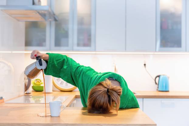 Tired,Woman,Sleeping,On,The,Table,In,The,Kitchen,At