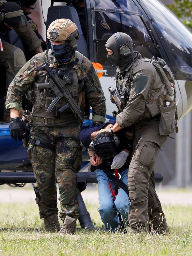 Police escort the suspect for Solingen's stabbing rampage, in Karlsruhe