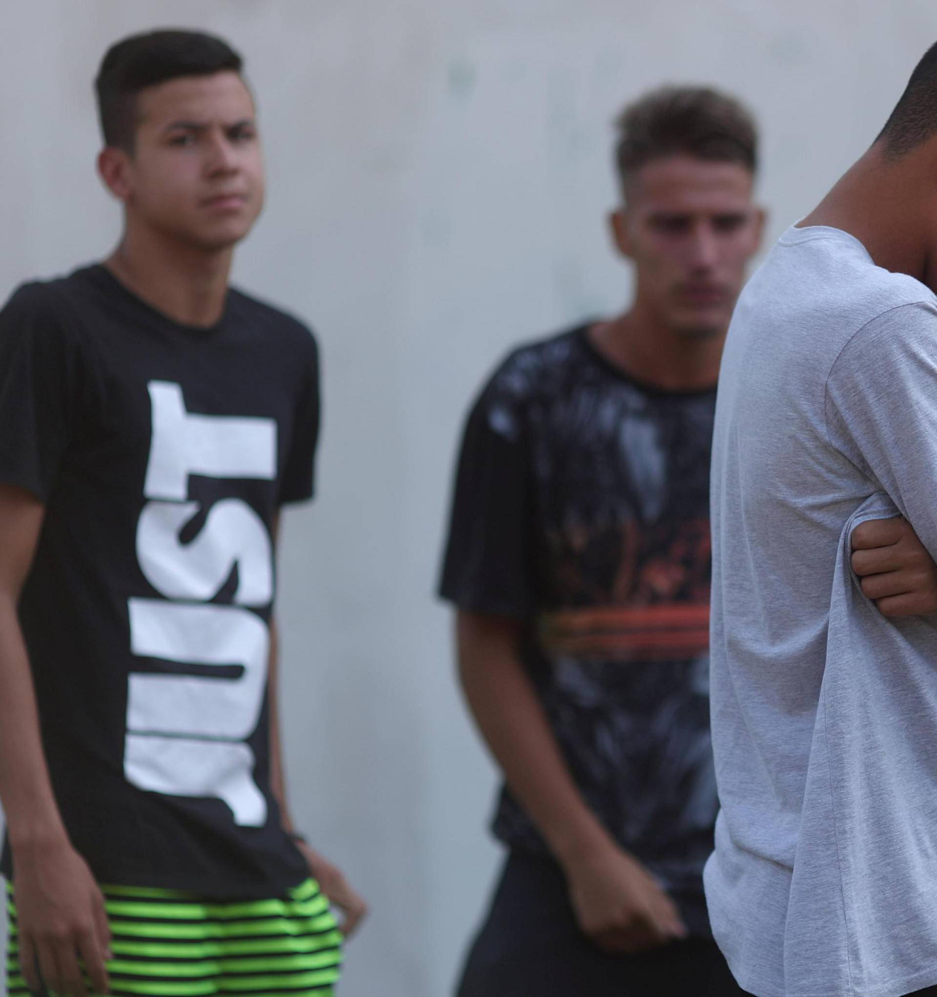 People wait for information in front of the training center of Rio's soccer club Flamengo, after a deadly fire in Rio de Janeiro