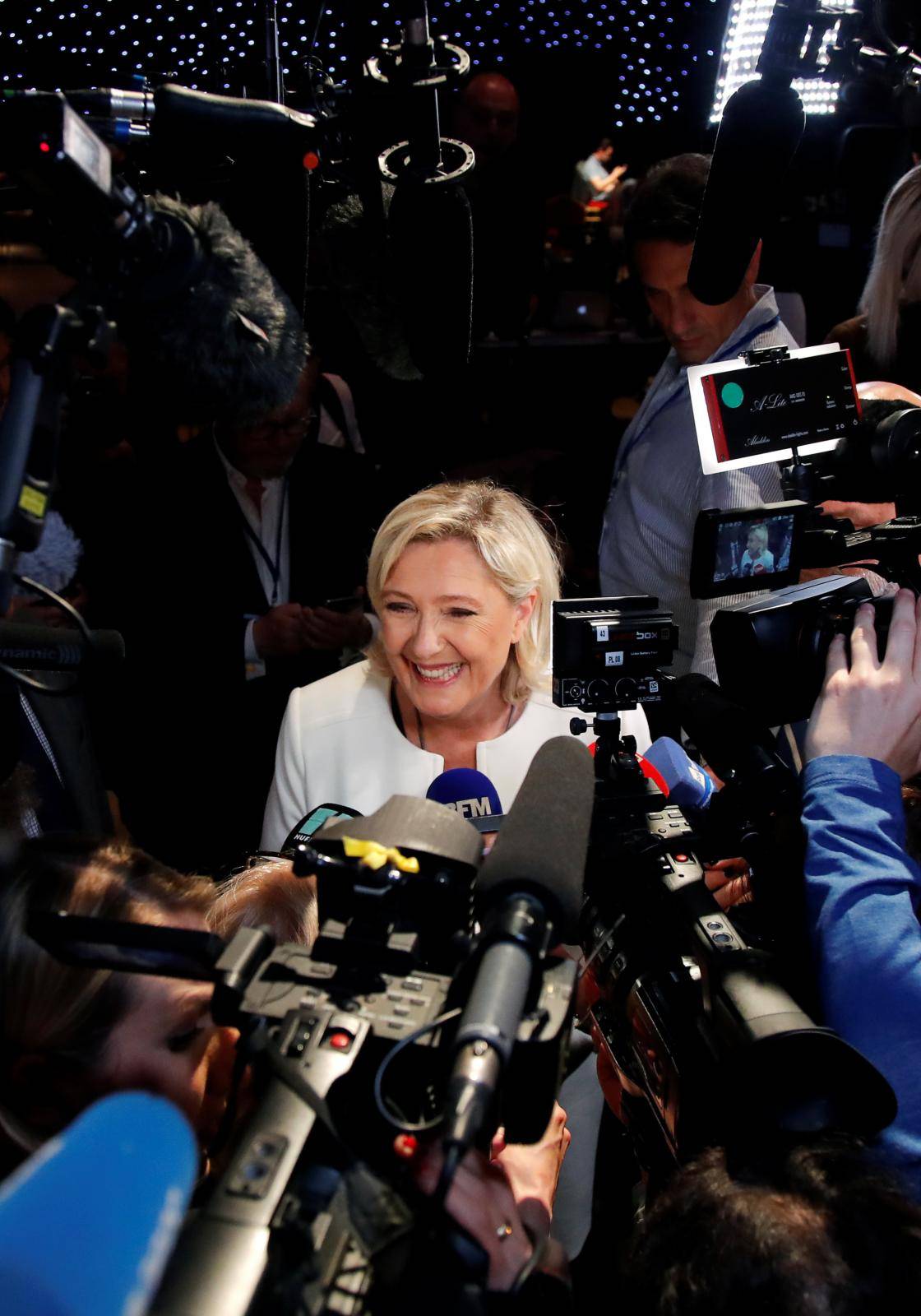 French far-right National Rally (Rassemblement National) party leader Marine Le Pen talks to the media after the first results in Paris
