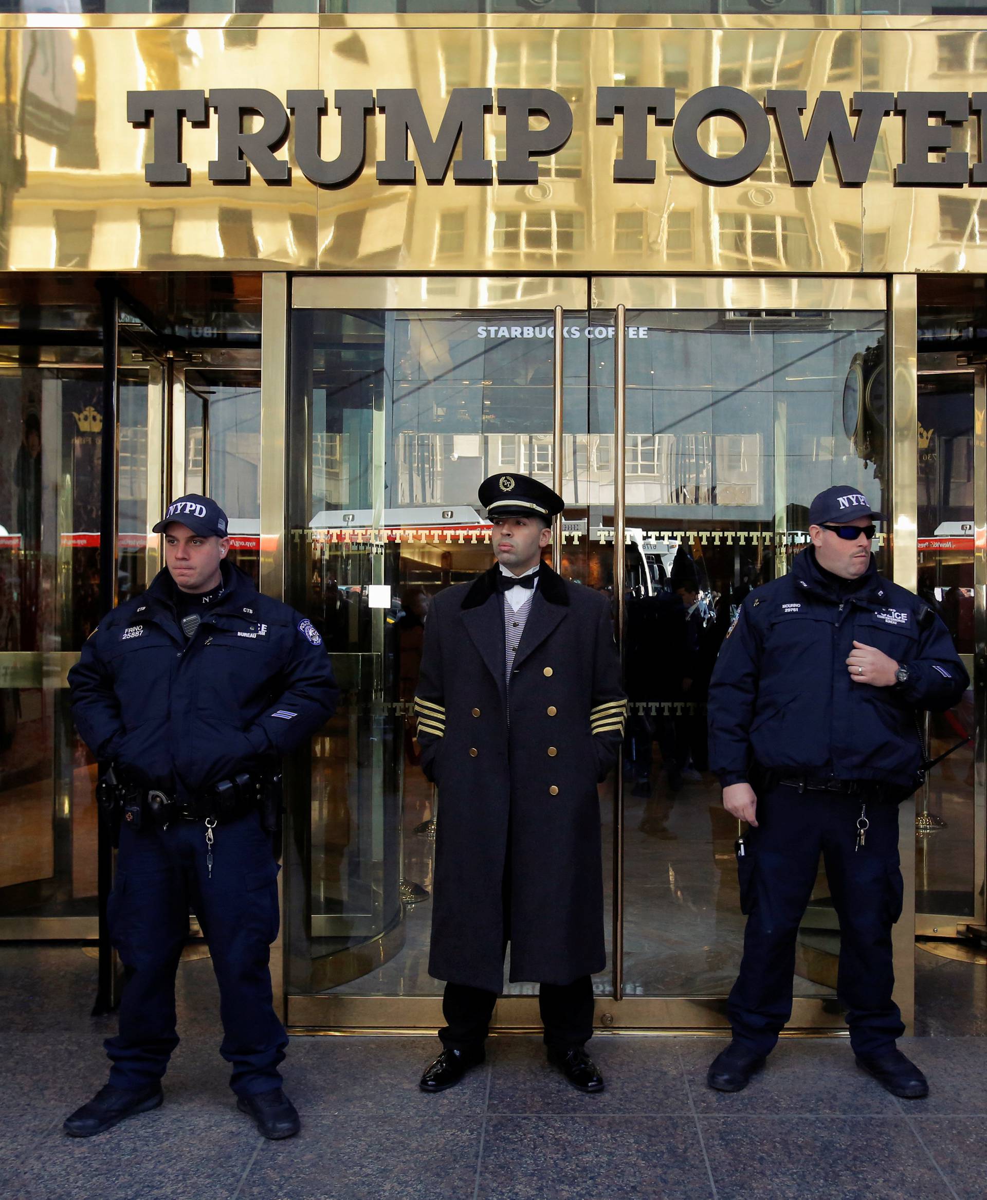Members of the New York Police Department's Counterterrorism Bureau stand with a doorman outside U.S. Republican presidential nominee Donald Trump's Trump Tower ahead of the U.S. presidential election in Manhattan, New York