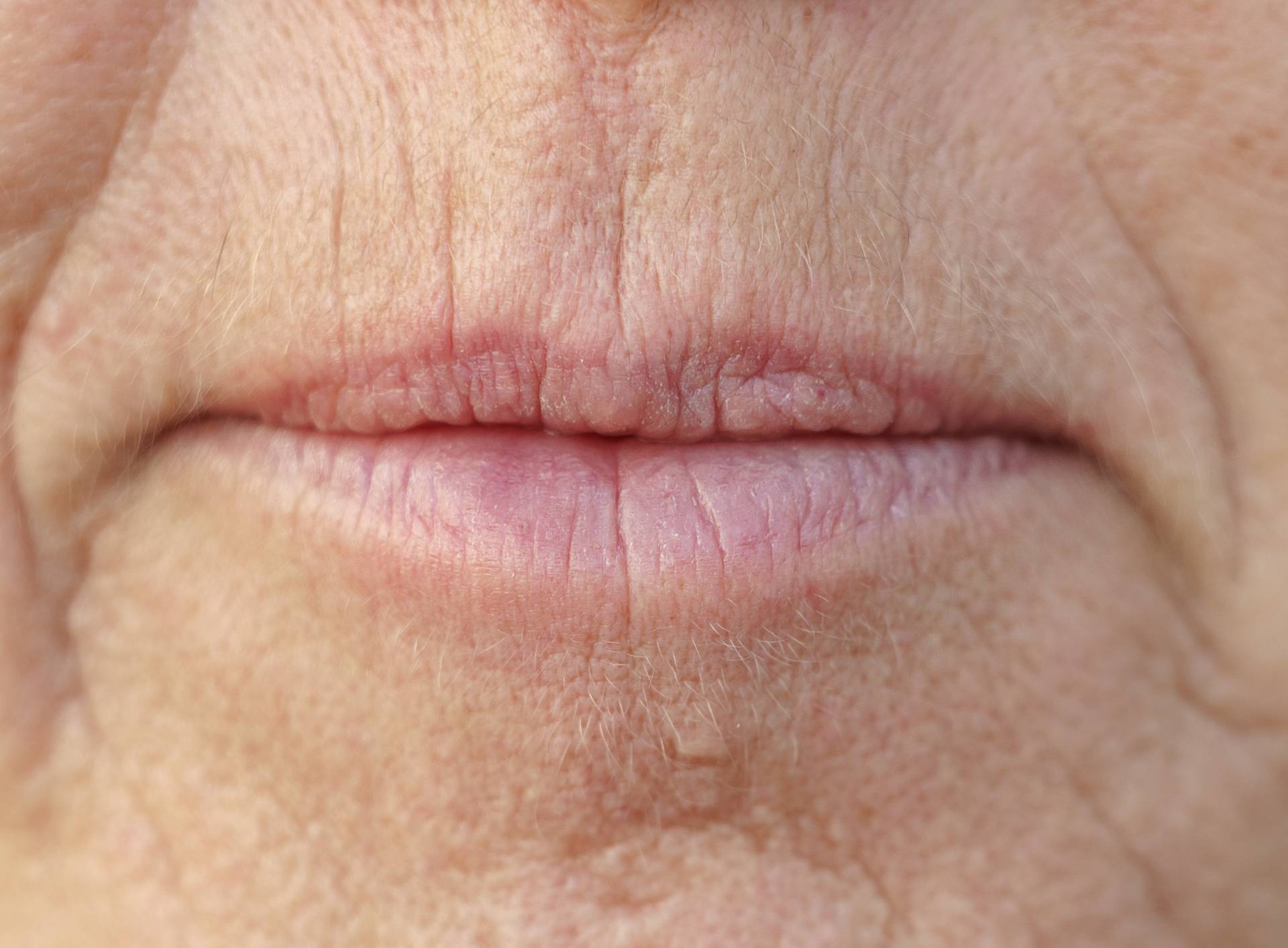 Extreme Closeup on the mouth of a middle-aged woman