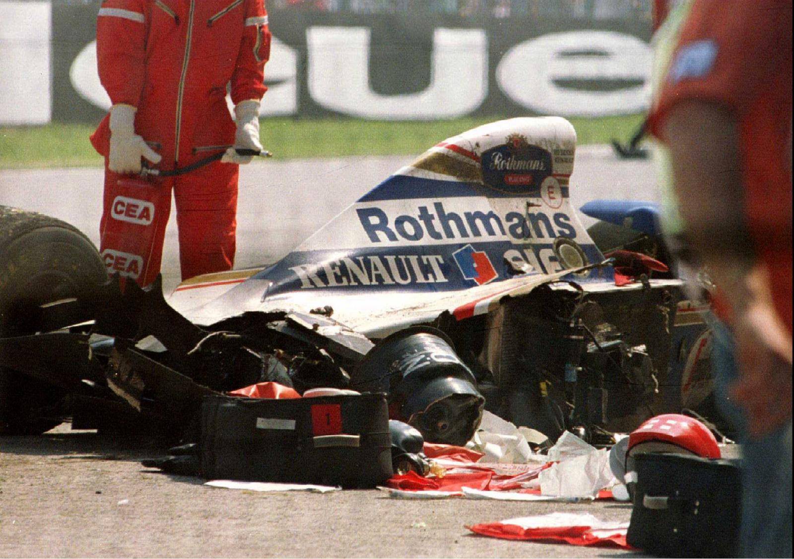 FILE PHOTO: Blood-stained medical equipment is seen surrounding Senna's Williams Renault car in Imola