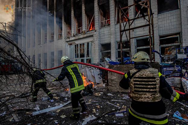 Rescuers work at a site of an industrial building damaged by an airstrike in Kyiv