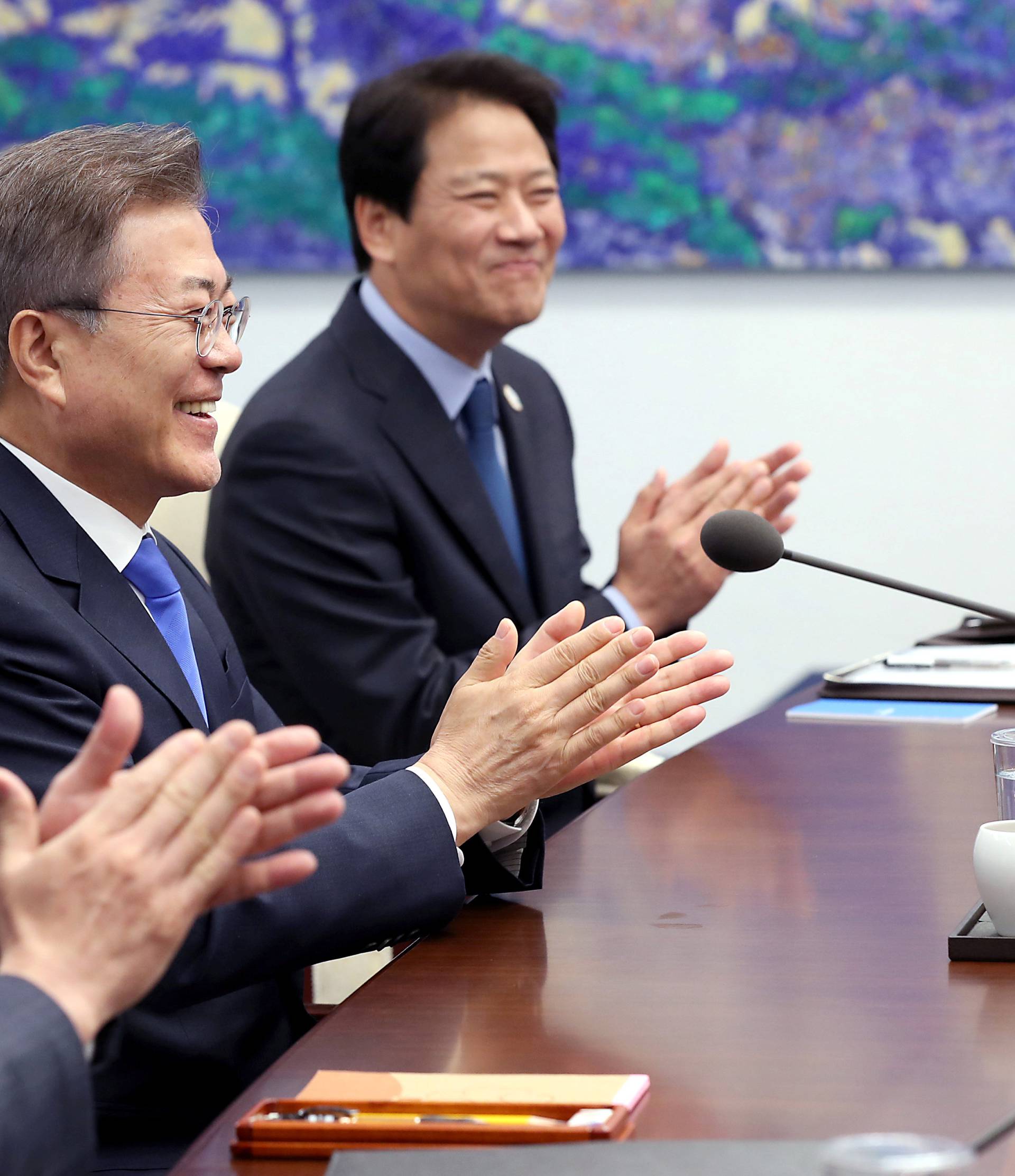 South Korean President Moon Jae-in applauds during a meeting with North Korean leader Kim Jong Un at the Peace House