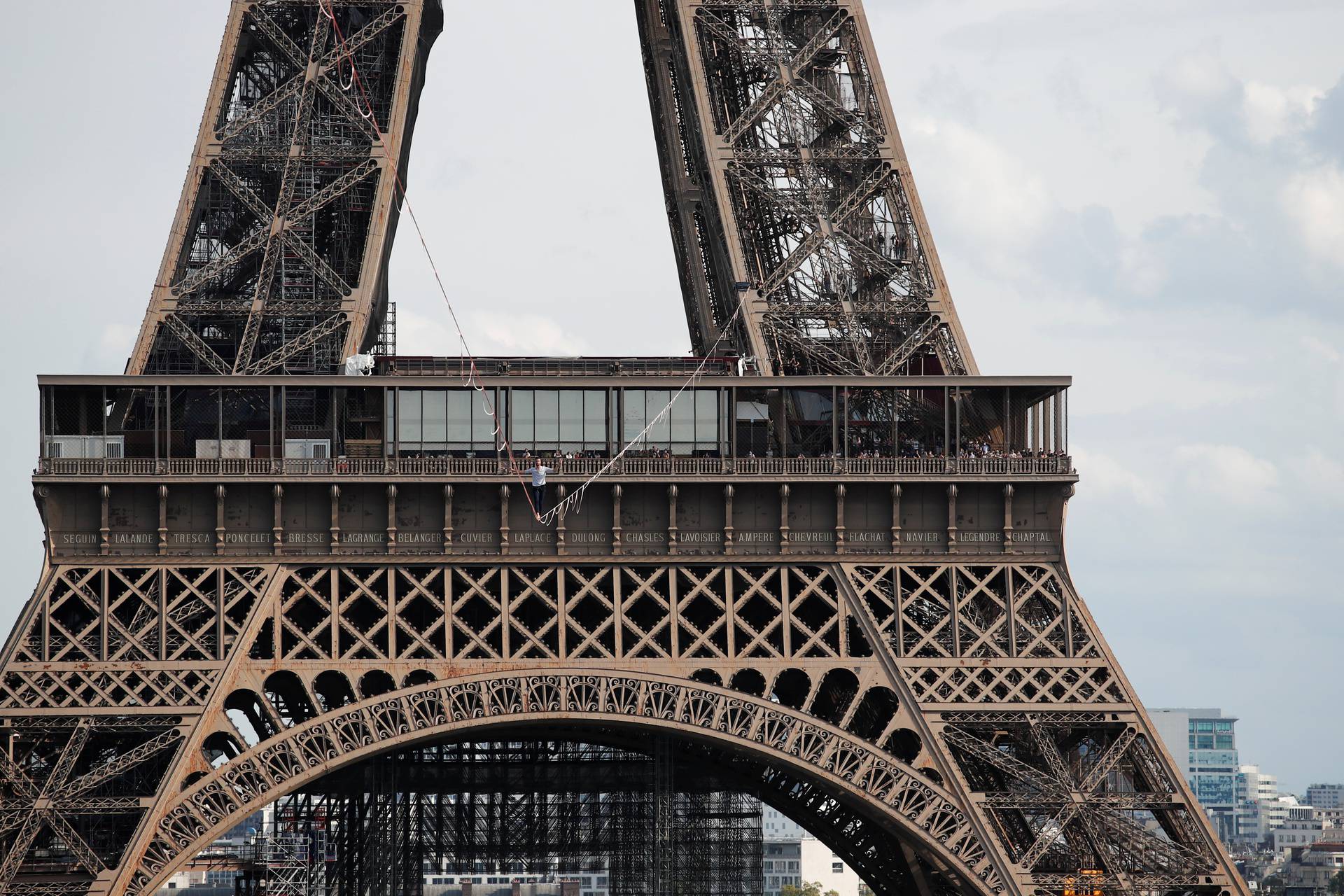 French acrobat Nathan Paulin walks on a slackline between the Eiffel Tower and the Theatre National de Chaillot as part of events around France for National Heritage Day