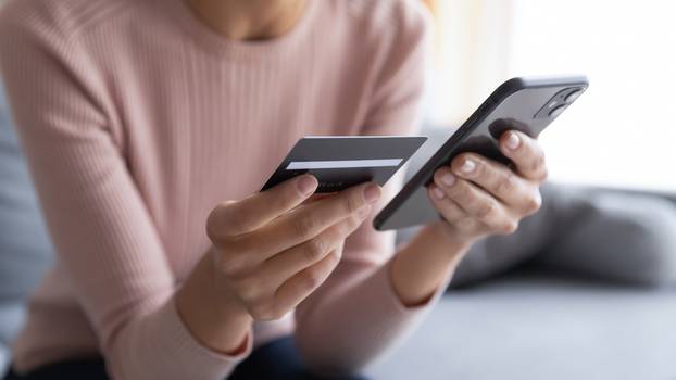 Close,Up,Female,Hands,Holding,Credit,Card,And,Smartphone,,Young