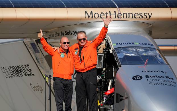 Andre Borschberg, the Swiss pilot of Solar Impulse 2, is greeted by fellow pilot and countryman Bertrand Piccard after landing at Cairo Airport