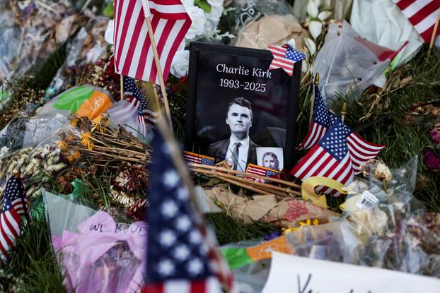 FILE PHOTO: People pay their respects at a memorial for slain conservative commentator Charlie Kirk, at Utah Valley University