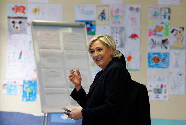 Marine Le Pen, French National Front political party candidate for French 2017 presidential election,  smiles before voting in the second round of 2017 French presidential election at a polling station in Henin-Beaumont