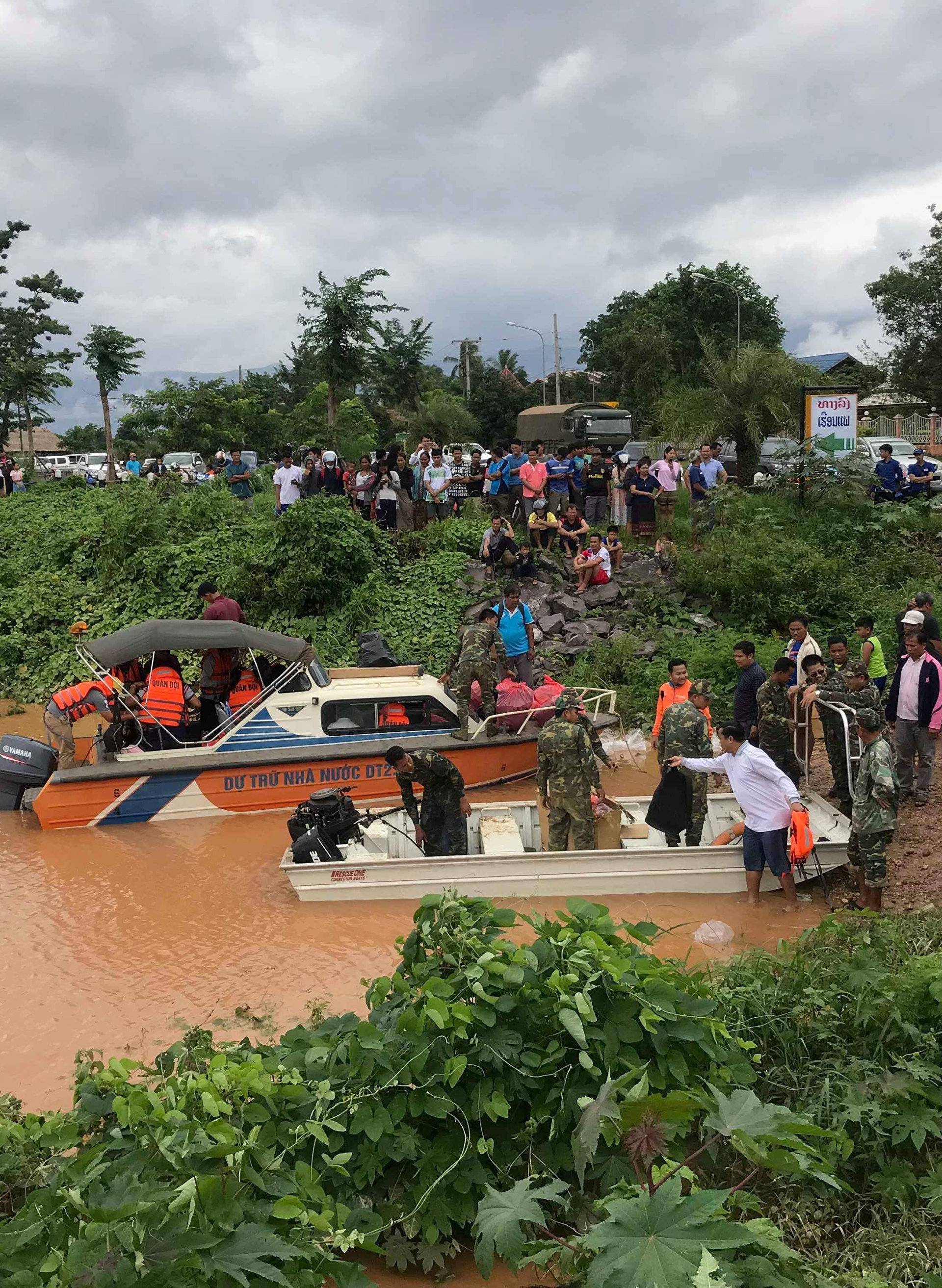 Rescuers work at a flooded site after a hydropower dam collapse in Attapeu Province