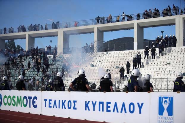 Fans of PAOK Salonika and AEK Athens clash before the Greek Cup Final soccer game at Panthessaliko stadium in Volos