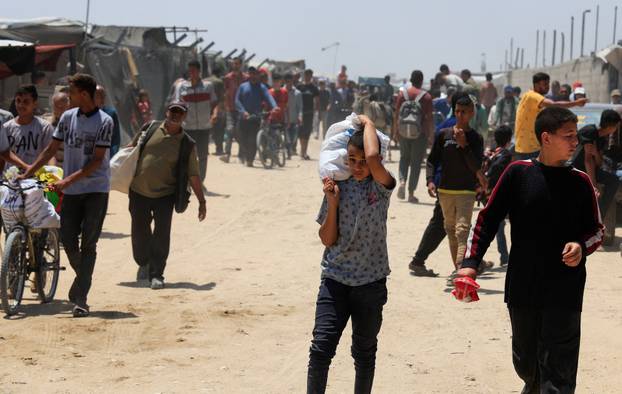 Palestinians carry aid supplies they received from the U.S.-backed Gaza Humanitarian Foundation, in Khan Younis
