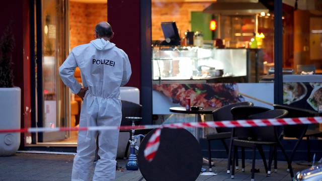 A police forensic expert works outside where a 21-year-old Syrian refugee killed a woman with a machete in Reutlingen