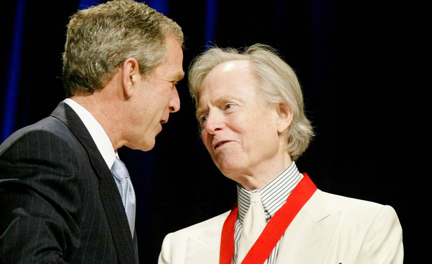 FILE PHOTO: Author Wolfe stands with U.S. President George W. Bush in Washington