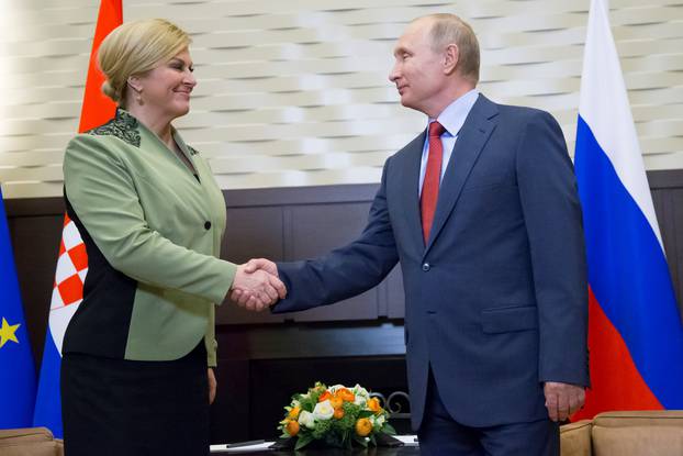 Putin shakes hands with Croatian President Grabar-Kitarovic during their meeting in Sochi