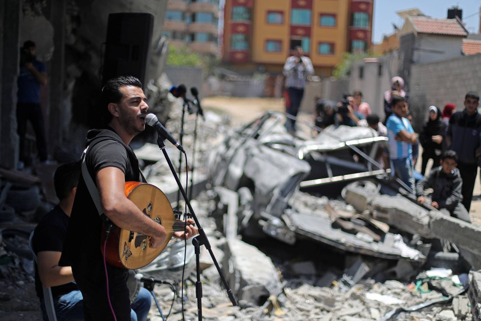 Palestinian singer performs during a musical event calling to boycott the Eurovision Song Contest hosted by Israel, in Gaza City