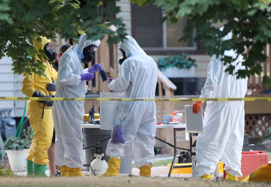 FILE PHOTO: FBI and law enforcement officers in hazmat suites prepare to enter a house which FBI says was investigating "potentially hazardous chemicals" in Logan